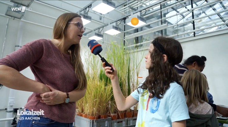 Dr. Alina Klaus mit einem Kinderreporter in der Klimakammer - Screenshot der Lokalzeit Aachen vom 04.11.2024